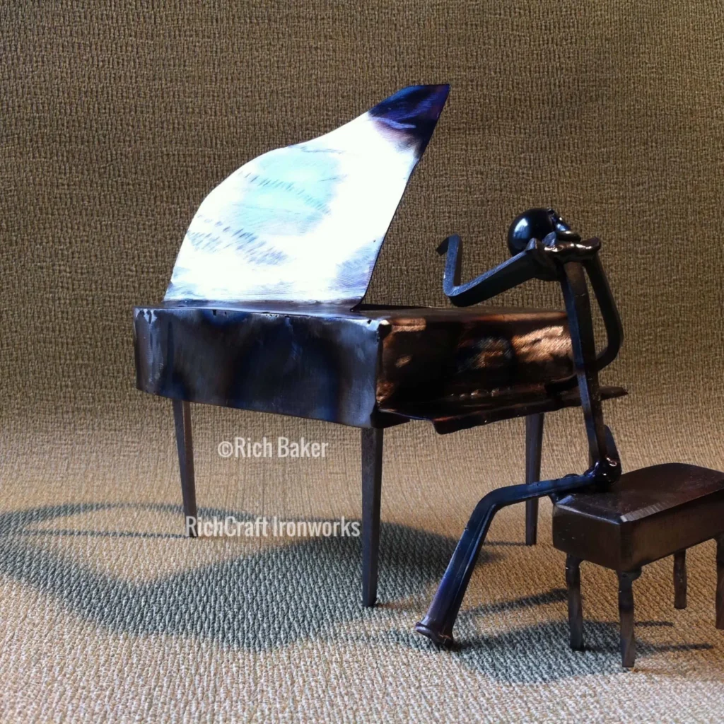 A a small metallic figure of a man playing piano.