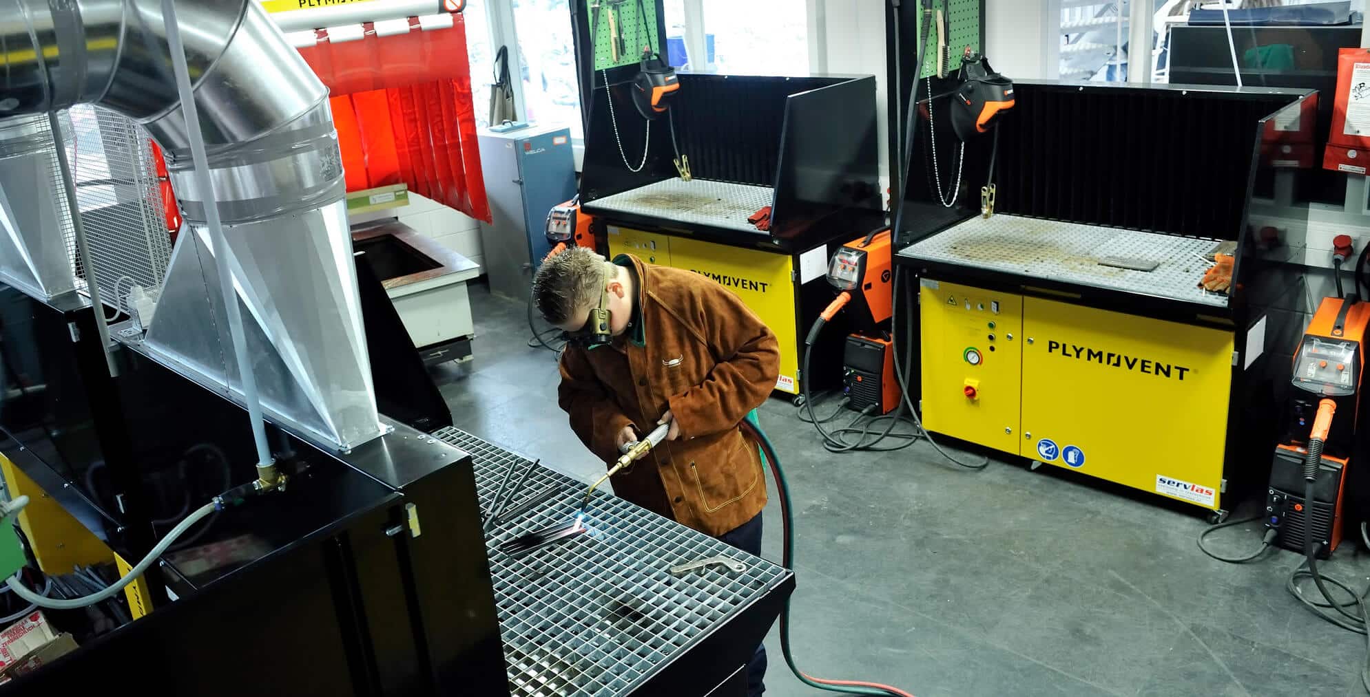 Man using Plymovent Downdraft Table while welding as header for the contact page