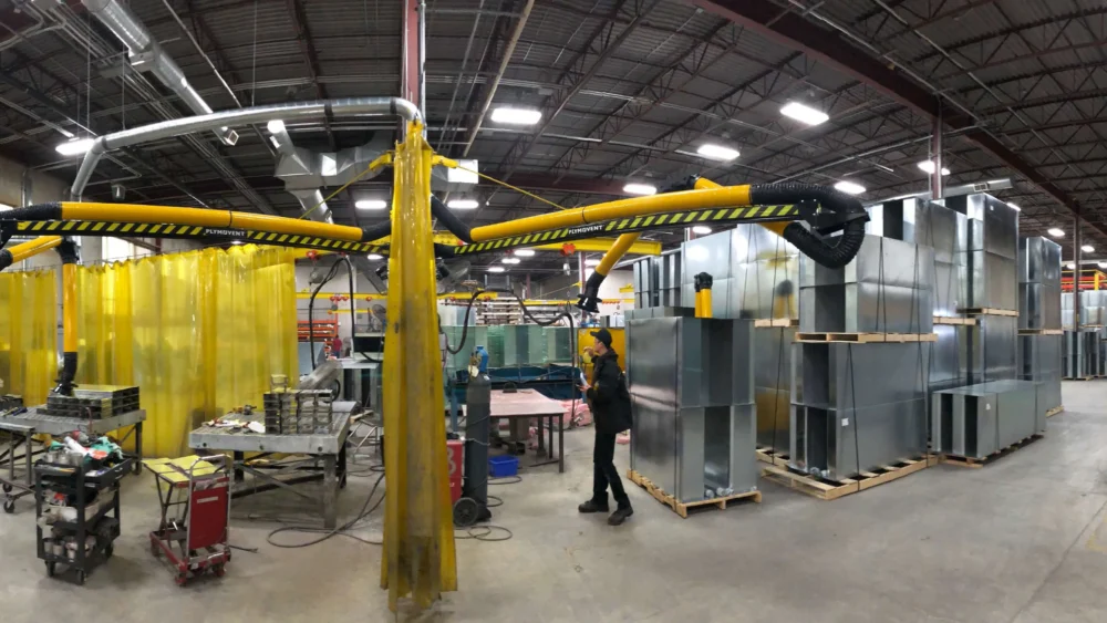 Picture of a manufacturing plant/workshop where multiple Remove The Fume fume extraction arms are present.