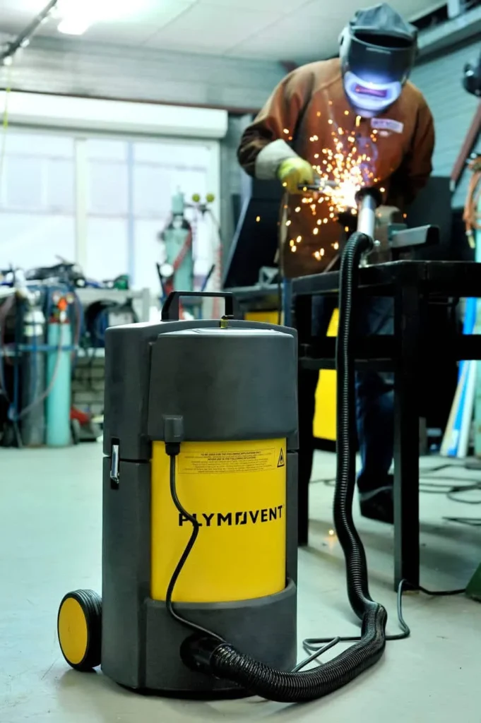 welder using a Plymovent portable high vacuum welding fume extractor which is sucking all the harmful fumes away from the breathing zone of the welder. 