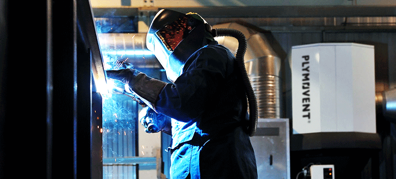 Gentleman welding with Plymovent System in use to extract welding fumes.