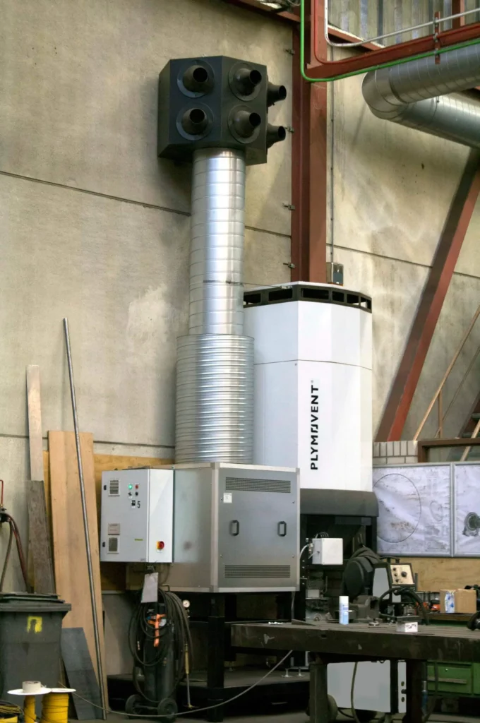 A silver colored diluter system from Plymovent installed in a manufacturing facility. 