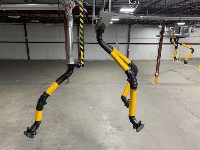 a facility with multiple yellow and black  colored Remove The Fume's fume extraction arms present
